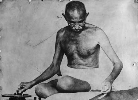 Gandhiji spinning on a box charkha.jpg